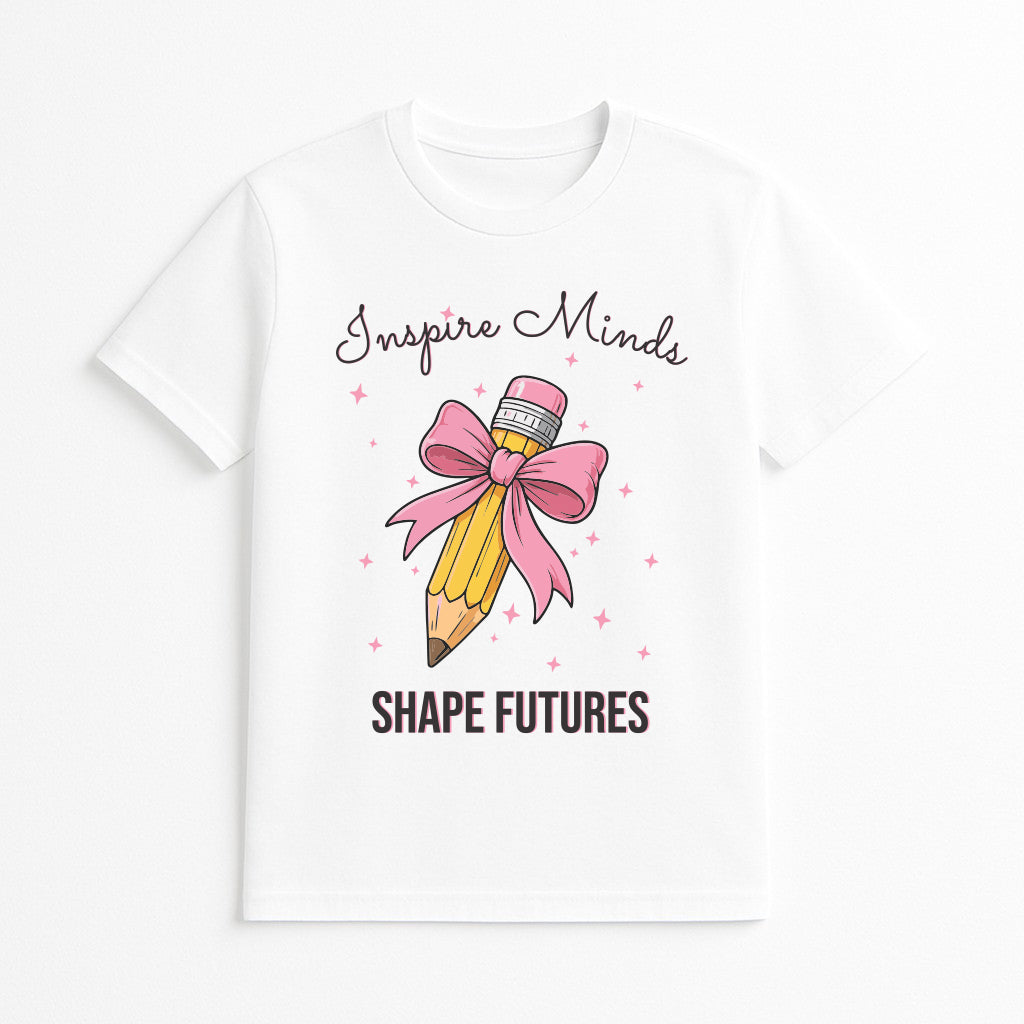White t-shirt with a pencil and bow design and text 'Inspire Minds Shape Futures' on a white background
