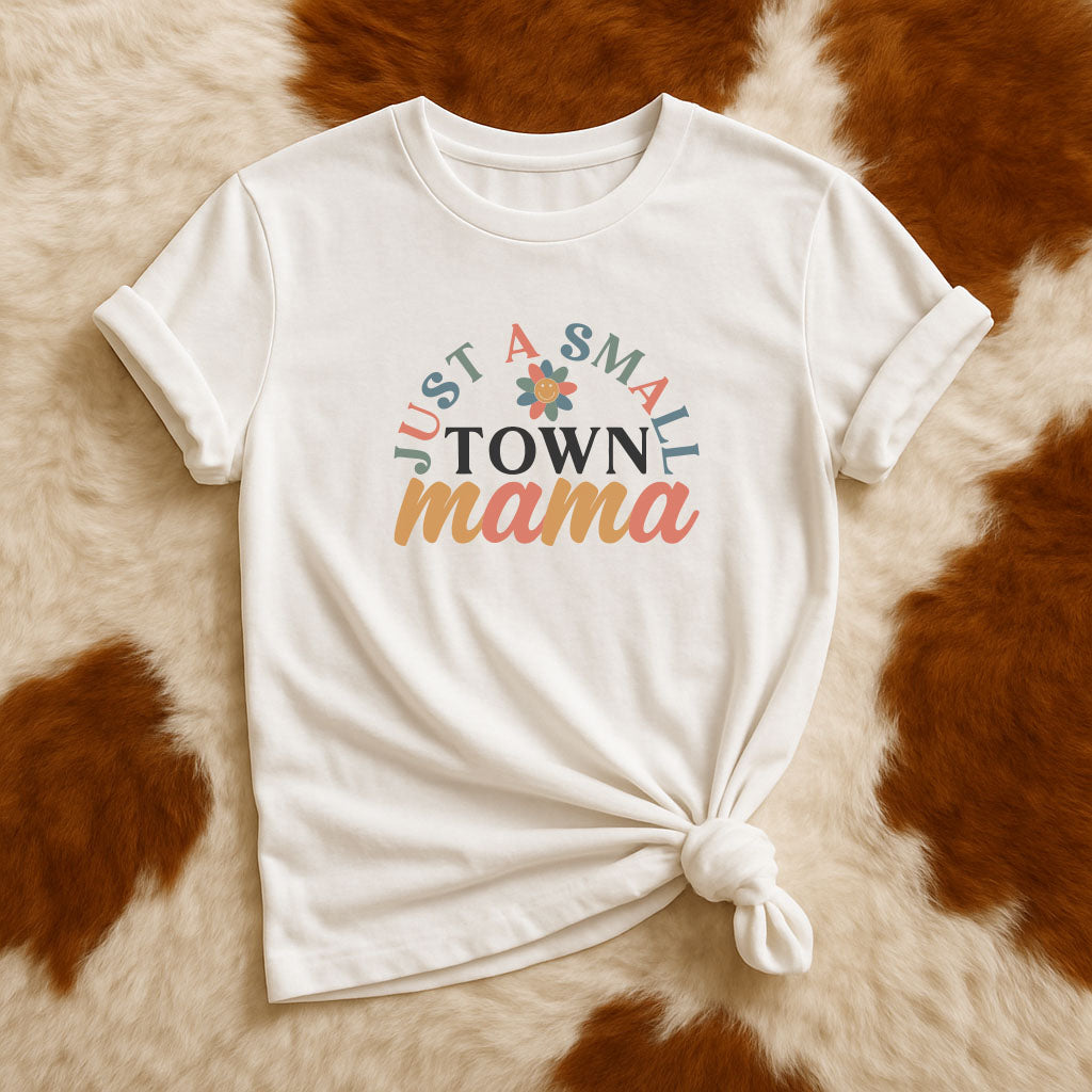 White t-shirt with 'Just a Small Town Mama' text on a brown and white fur background