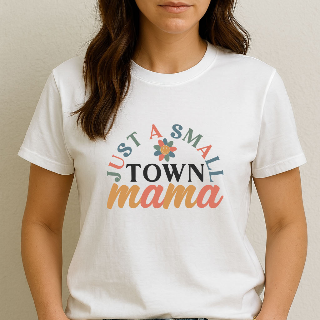 Woman wearing a white t-shirt with 'Just a Small Town Mama' text design.