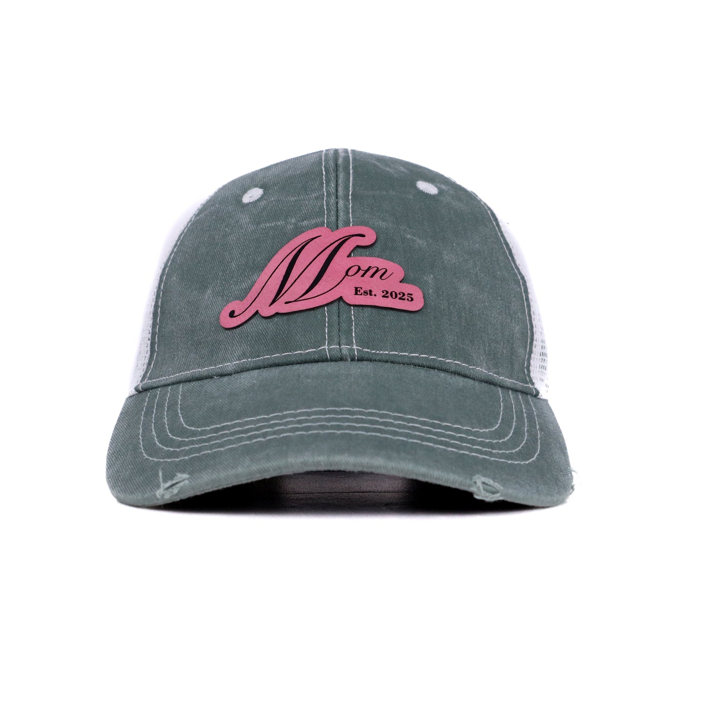 Front view of Mom Est. 2025 trucker hat in sage green with rose pink leather patch
