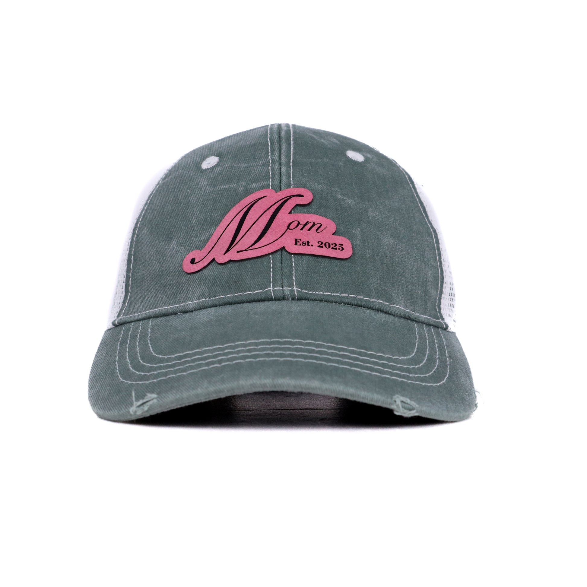 Front view of Mom Est. 2025 trucker hat in sage green with rose pink leather patch