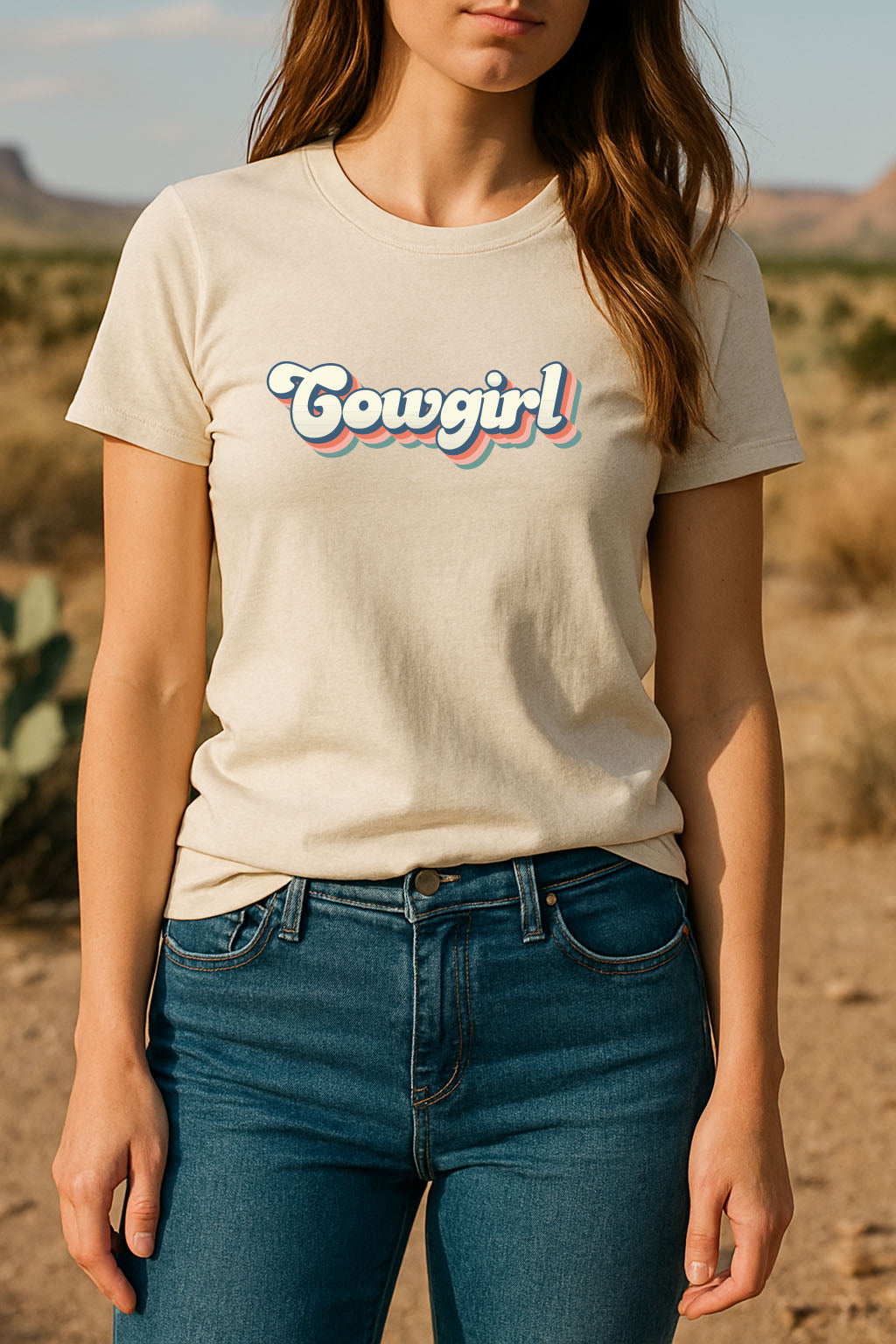 Woman wearing a natural color retro Cowgirl tee with jeans in the desert