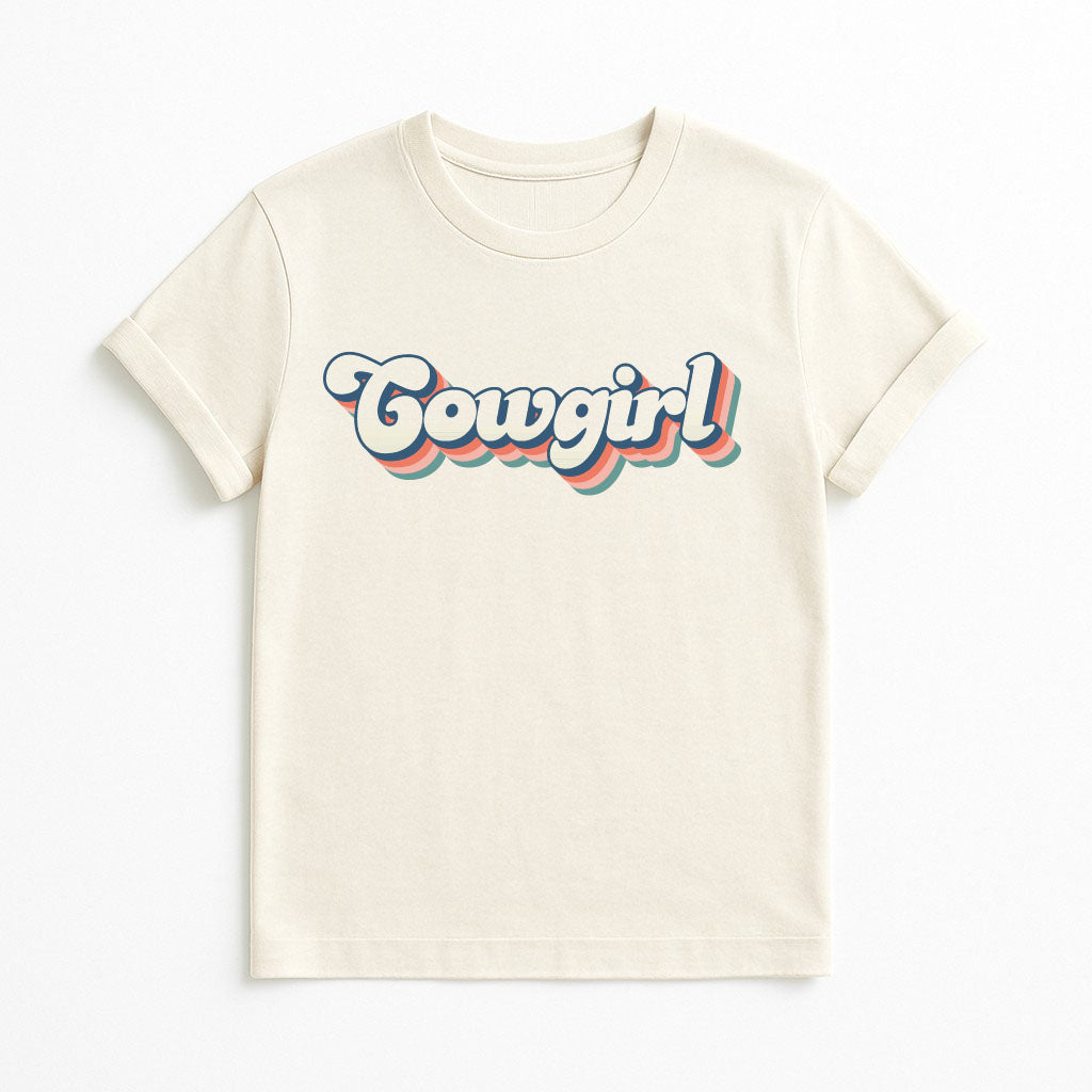 Natural color T-shirt with retro rainbow Cowgirl text design, on clean background
