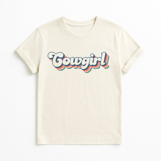 Natural color T-shirt with retro rainbow Cowgirl text design, on clean background