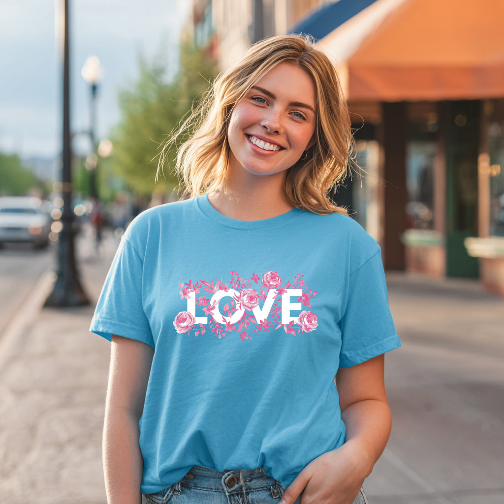 Woman wearing blue floral LOVE teacher graphic tee outdoors casual spring outfit