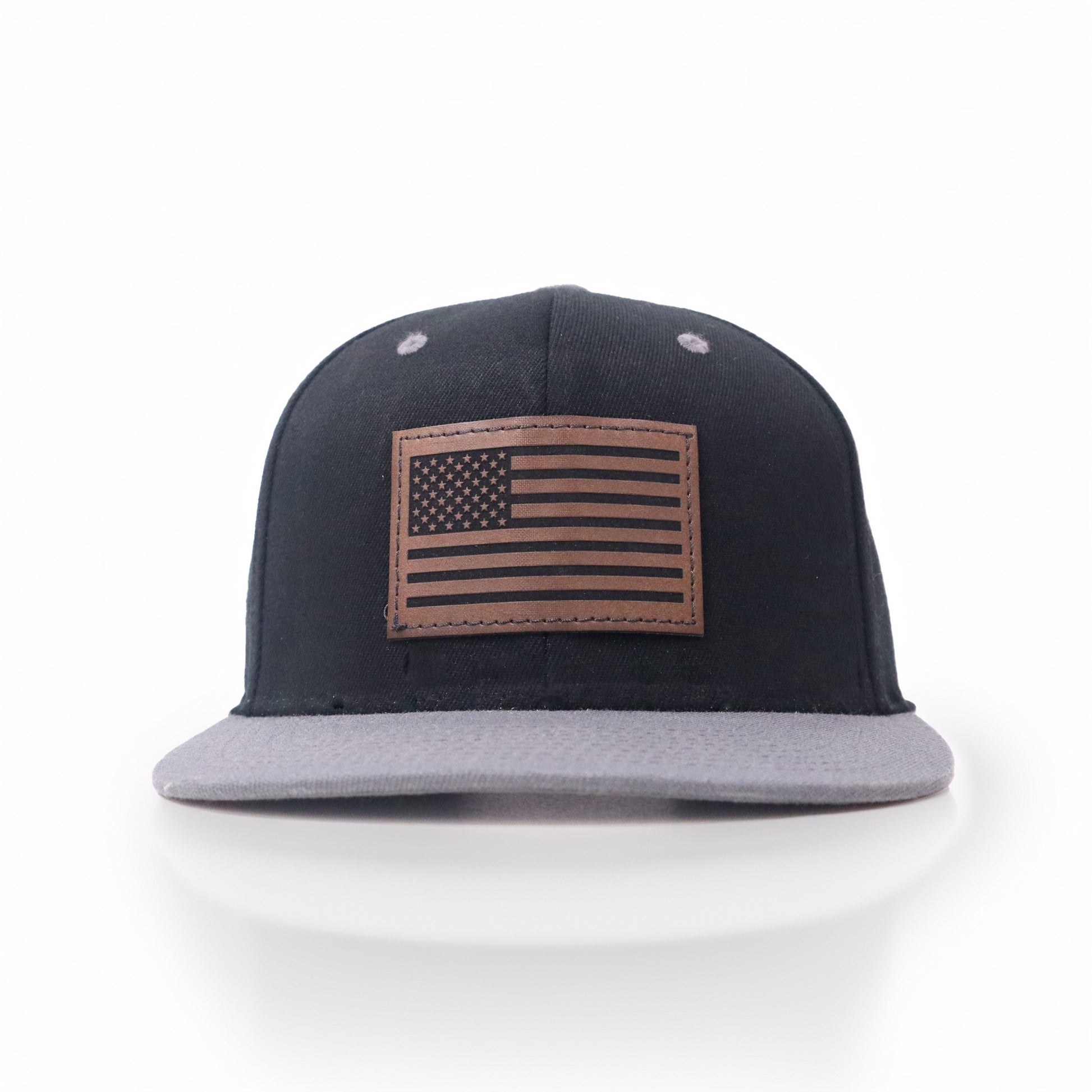 Black and gray cap with American flag patch on a white background